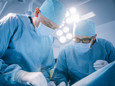 Head-and-shoulders shot of two surgeons operating